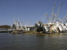 Two vessels grounded on land on their sides. 
