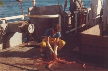 A woman on a boat holding an octopus.