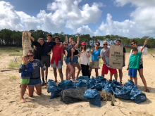 A group photo on a beach.