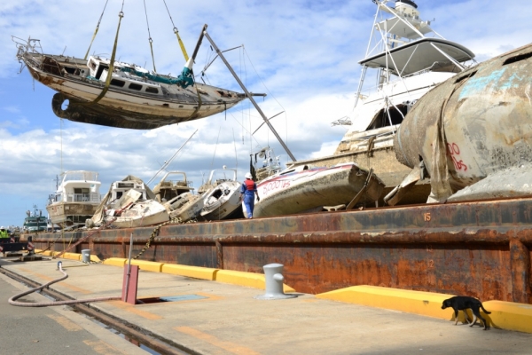 A vessel being lifted with a crane barge. 