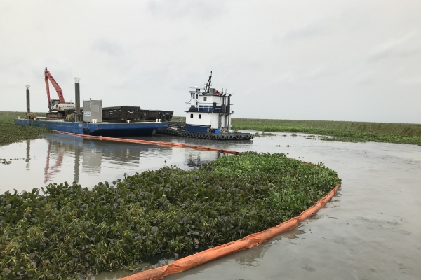Pollution boom around a marsh area. 