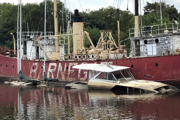 Abandoned vessels sinking by the water's edge.