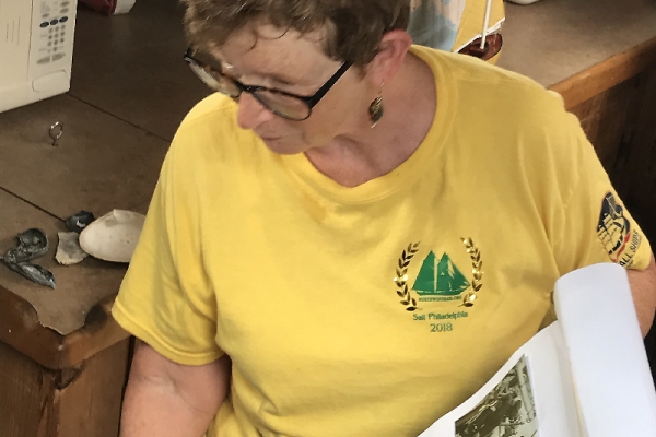 Instructor shows photos of old boats to students. 