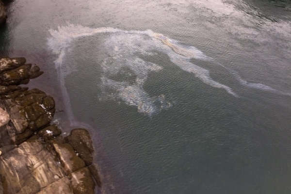 An aerial view of an oil sheen in water.