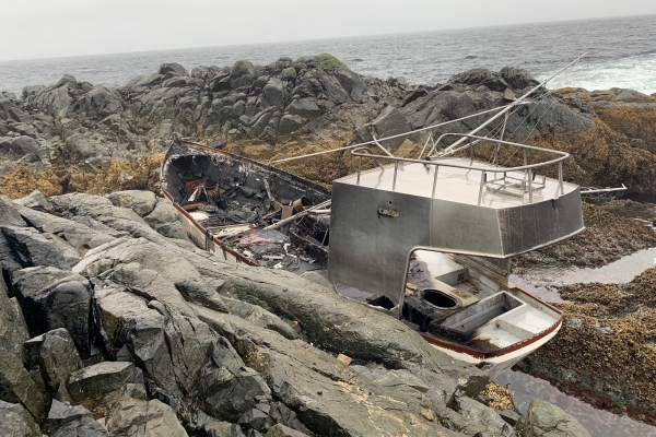 A grounded vessel on a rocky shore.